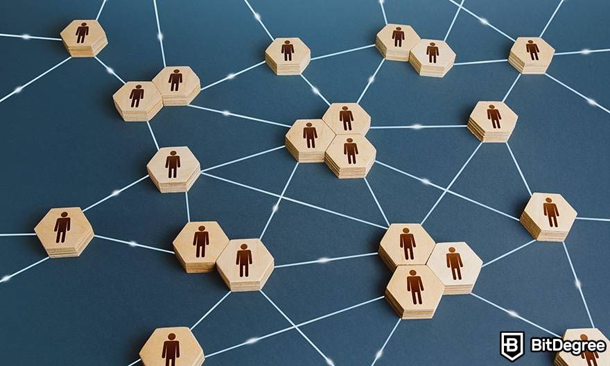 Apa itu uang fiat dalam crypto: Gambar manusia pada blok kayu yang saling terhubung dengan benang, menggambarkan simulasi jaringan terdesentralisasi. 