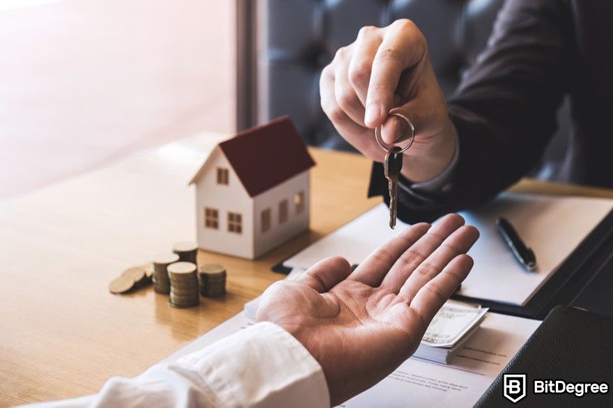 Como transferir criptomoedas para uma conta bancária: corretor imobiliário dando uma chave ao cliente.